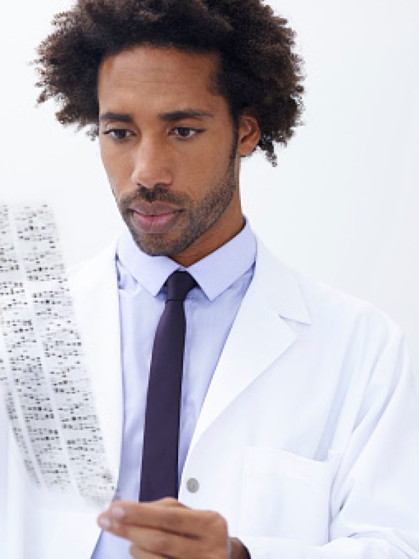 Shot of a handsome male scientist analyzing a printout of DNA signatures